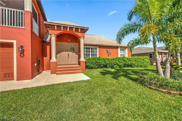 view of front facade with a garage and a front lawn