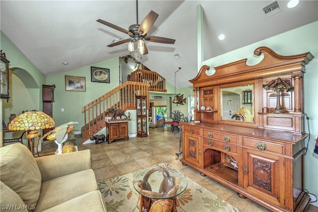 tiled living room with high vaulted ceiling and ceiling fan