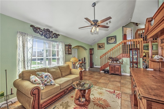 living room with lofted ceiling, light tile patterned floors, and ceiling fan