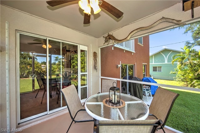 sunroom featuring ceiling fan and plenty of natural light