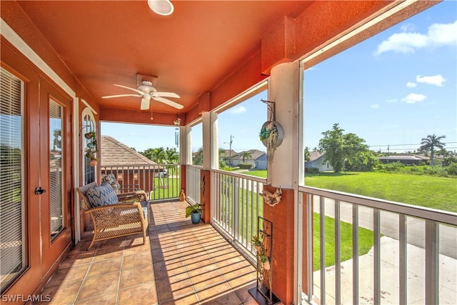 wooden deck with a yard and ceiling fan