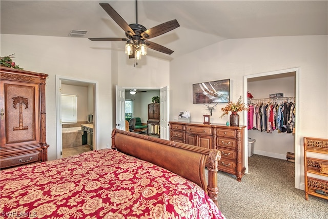 carpeted bedroom with lofted ceiling, ceiling fan, ensuite bathroom, a walk in closet, and a closet