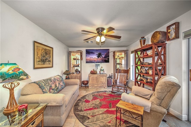 living room featuring light tile patterned flooring and ceiling fan