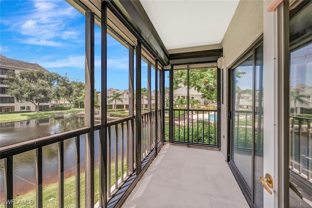 900 Arbor Lake Dr Unit 206, Naples, FL 34110 - unfurnished sunroom with a water view