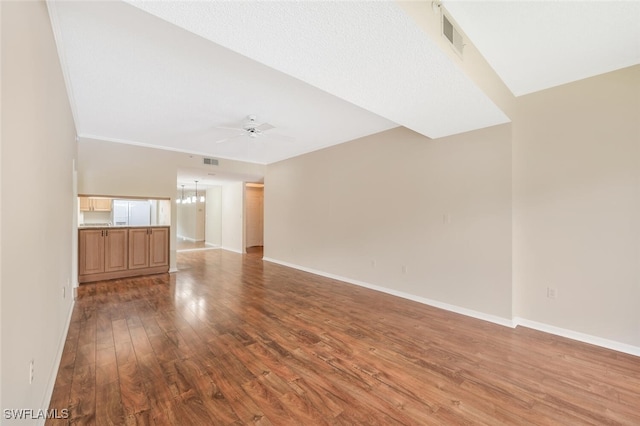 900 Arbor Lake Dr Unit 206, Naples, FL 34110 - unfurnished living room featuring ceiling fan with notable chandelier and hardwood / wood-style floors