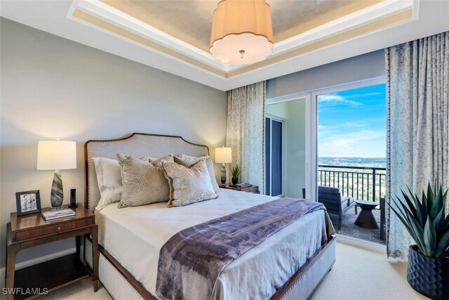 4800 Pelican Colony Blvd Unit Ph2103, Bonita Springs, FL 34134 - bedroom with access to exterior, a tray ceiling, light carpet, and a water view