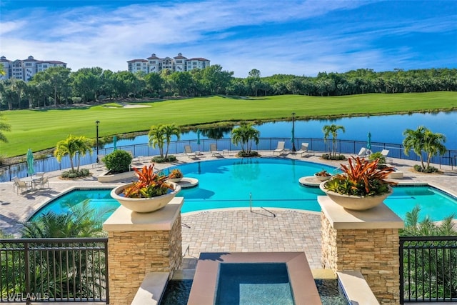 view of swimming pool featuring a water view and a patio area