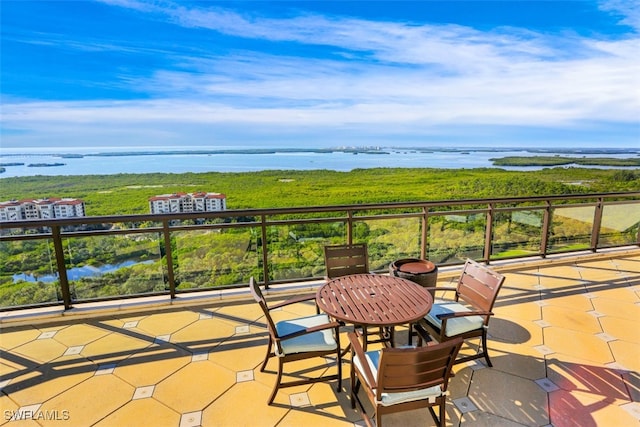 view of patio / terrace featuring a balcony and a water view