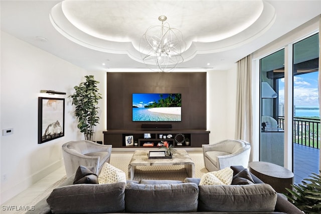 living room featuring a tray ceiling and a notable chandelier