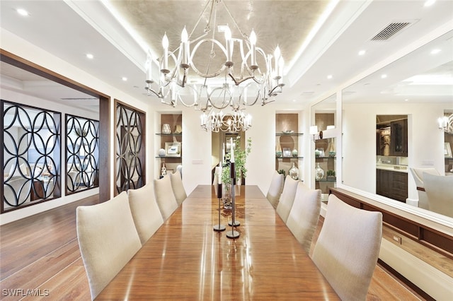 4800 Pelican Colony Blvd Unit Ph2103, Bonita Springs, FL 34134 - dining space with a chandelier, recessed lighting, a raised ceiling, wood finished floors, and built in features