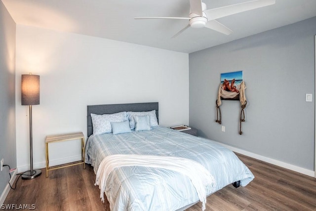 bedroom featuring ceiling fan, baseboards, and dark wood-style flooring