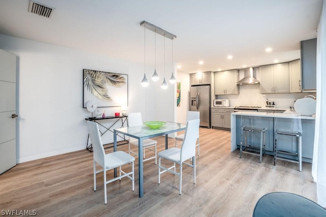 dining room with light hardwood / wood-style flooring