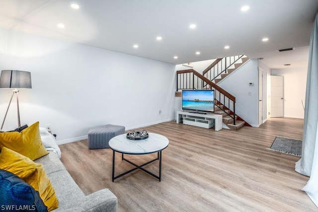 living area with light wood finished floors, baseboards, visible vents, stairs, and recessed lighting