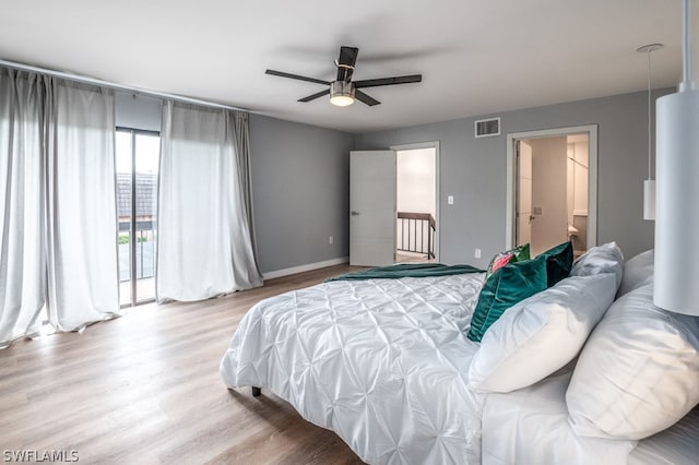 bedroom with hardwood / wood-style floors, access to outside, ensuite bath, and ceiling fan