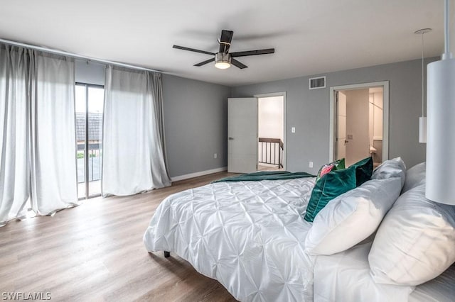 bedroom with baseboards, visible vents, ceiling fan, and wood finished floors