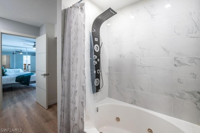 ensuite bathroom featuring a combined bath / shower with jetted tub, ceiling fan, ensuite bath, and wood finished floors