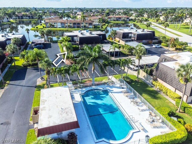 birds eye view of property with a water view and a residential view