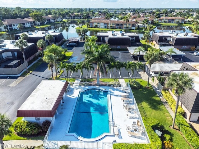 view of pool featuring a water view and a residential view