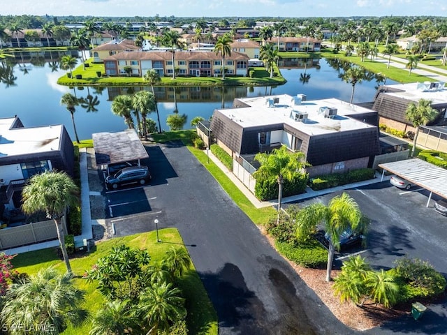 drone / aerial view with a water view and a residential view