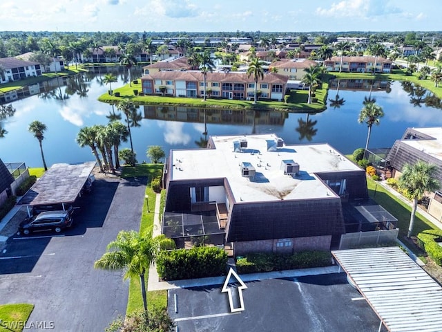 drone / aerial view with a water view and a residential view