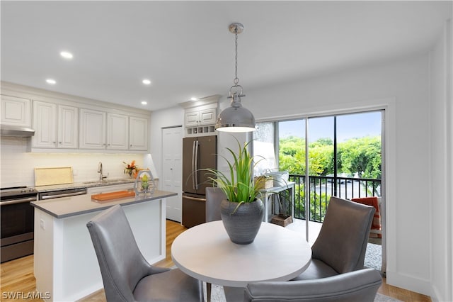 dining room featuring light hardwood / wood-style floors and sink