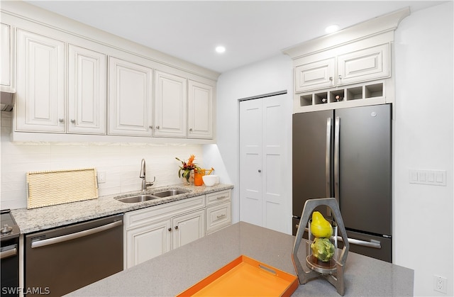 kitchen featuring appliances with stainless steel finishes, sink, and white cabinets