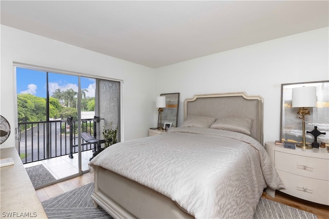 bedroom featuring access to exterior and light wood-type flooring