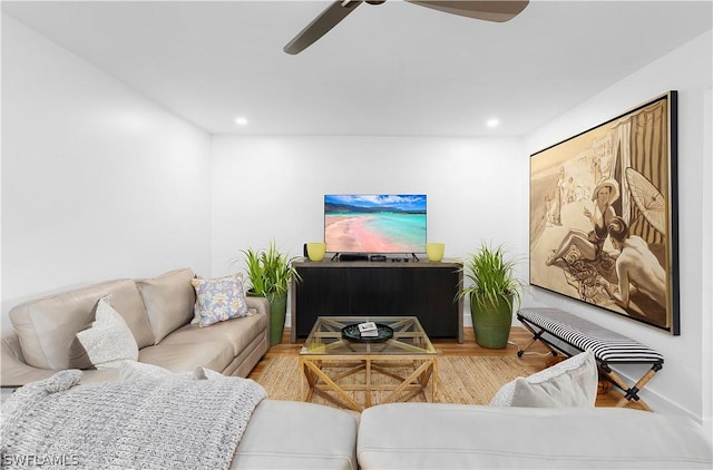 living room featuring ceiling fan and wood-type flooring