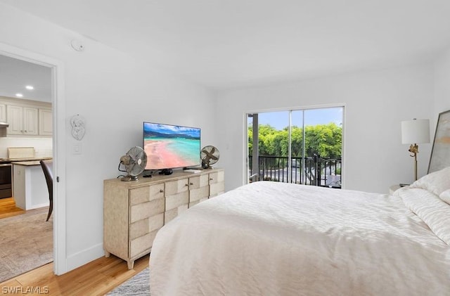 bedroom with access to outside and light wood-type flooring