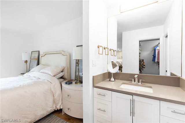 bedroom with dark wood-type flooring and sink