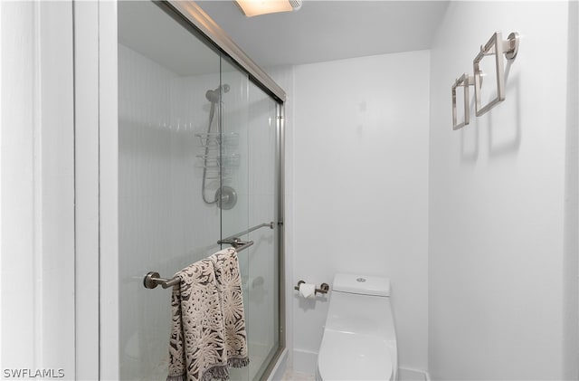 bathroom featuring toilet and walk in shower