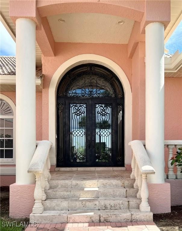 view of exterior entry featuring french doors