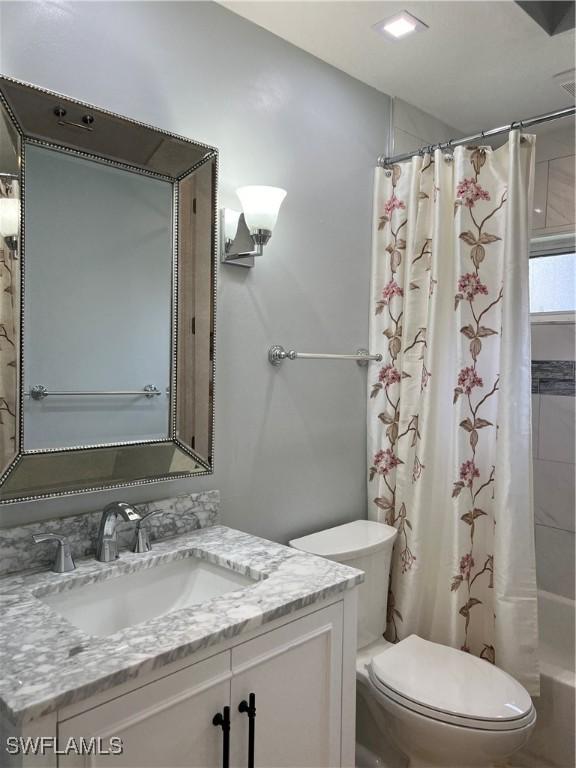 full bathroom with vanity, toilet, and shower / bath combo