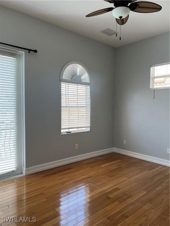 empty room featuring hardwood / wood-style flooring and ceiling fan