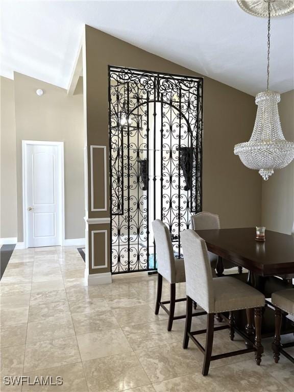 dining area featuring vaulted ceiling and a chandelier