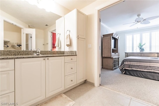 bathroom featuring crown molding, ceiling fan, and vanity