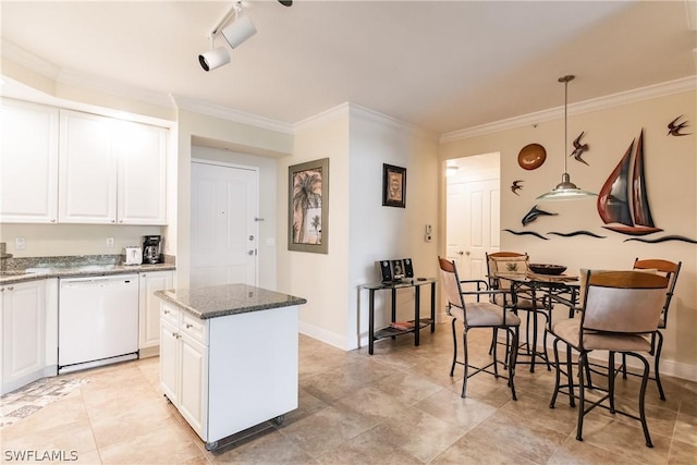 kitchen with dishwasher, white cabinets, dark stone counters, and decorative light fixtures