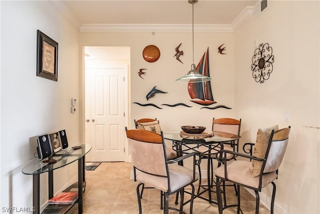 dining room with ornamental molding and light tile patterned flooring