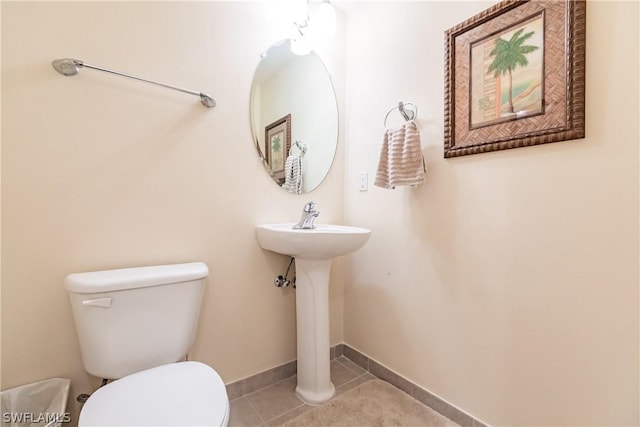 bathroom featuring tile patterned flooring, sink, and toilet