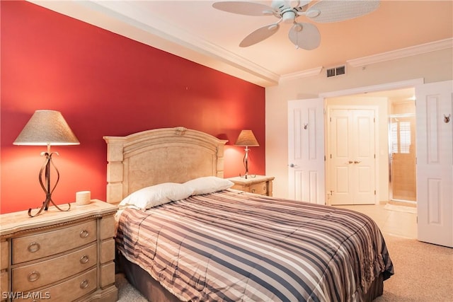 carpeted bedroom featuring ornamental molding, ensuite bathroom, and ceiling fan