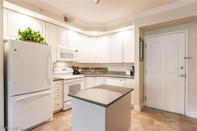 kitchen featuring sink, white appliances, white cabinetry, a center island, and light stone counters