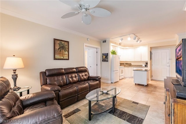 living room with light tile patterned floors, crown molding, track lighting, and ceiling fan