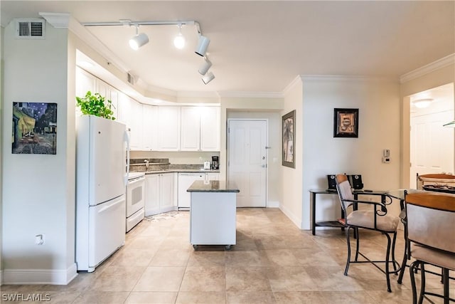 kitchen featuring sink, white cabinetry, ornamental molding, a kitchen island, and white appliances