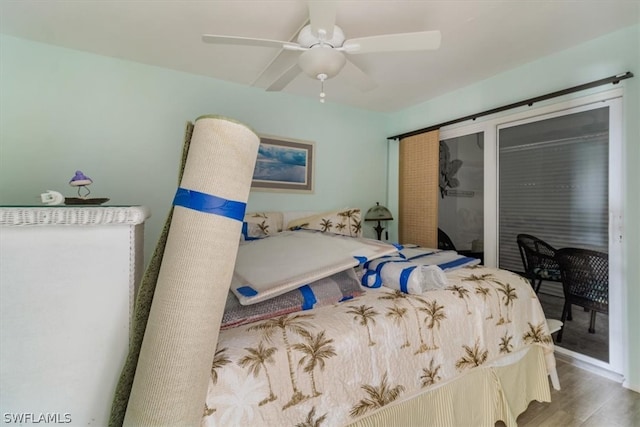 bedroom with ceiling fan and hardwood / wood-style flooring