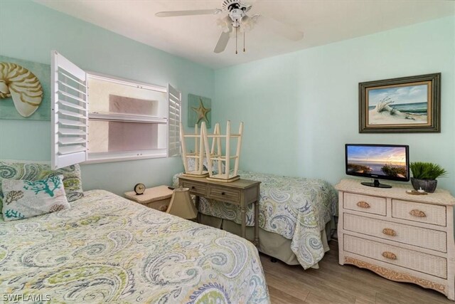 bedroom with ceiling fan and hardwood / wood-style floors