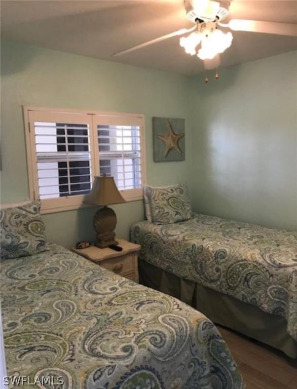 bedroom with hardwood / wood-style flooring and ceiling fan