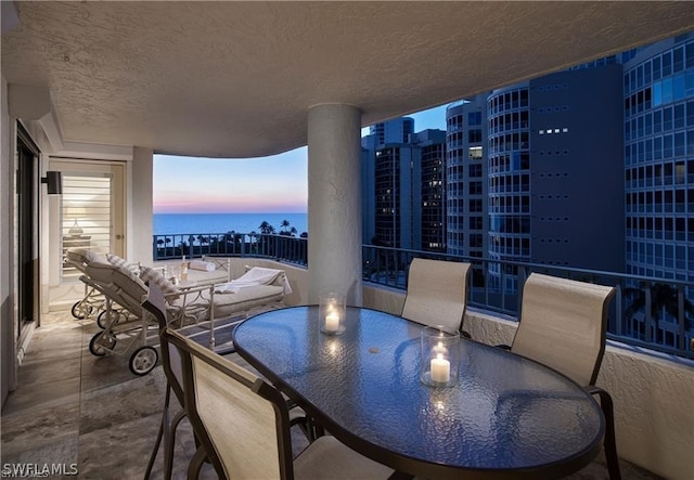 balcony at dusk with a water view