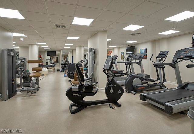 exercise room with a paneled ceiling