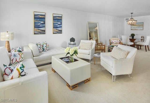 carpeted living room with a chandelier