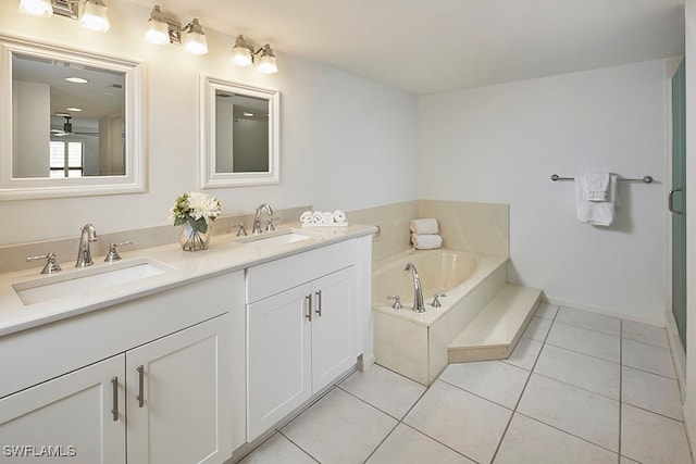 bathroom featuring vanity, a bath, and tile patterned floors